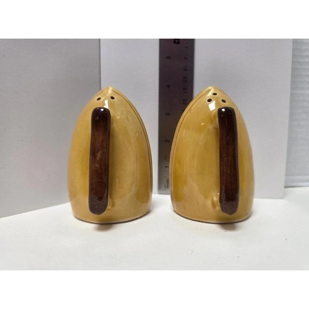 vintage souvenir salt and pepper shakers like marigold yellow iron